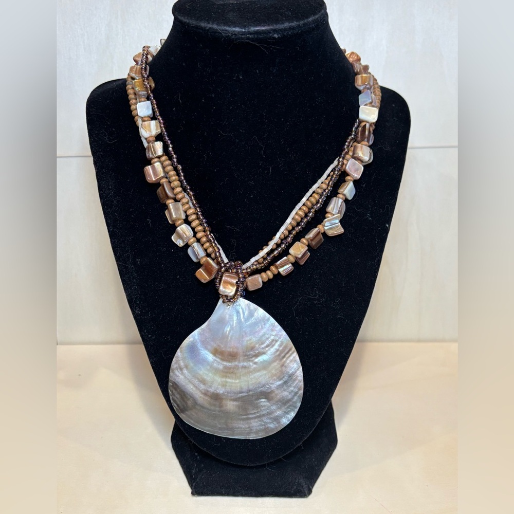 Shell abalone pendant with wood, shell, and seed beads use for the necklace.